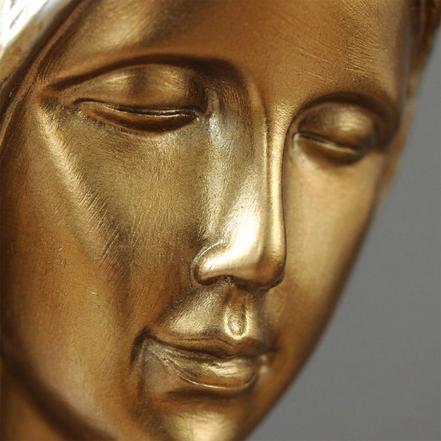 Golden female face carving close shot