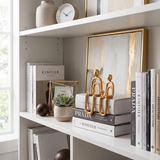 Golden human figurines bookshelf dried flower