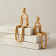 Golden sitting figurines on white books