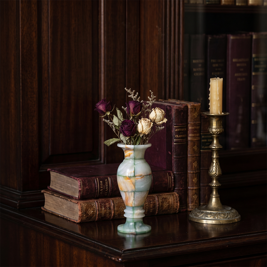 Green vein pedestal vase on traditional dark bookcase