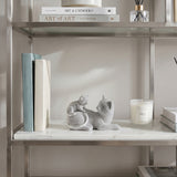 Grey cat figurine inside glass wall shelf