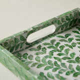 Handle cutout green foliage tray closeup