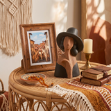 Hat woman sculpture on rattan roundside table