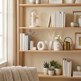 LOVE vases on shelf with books and flowers