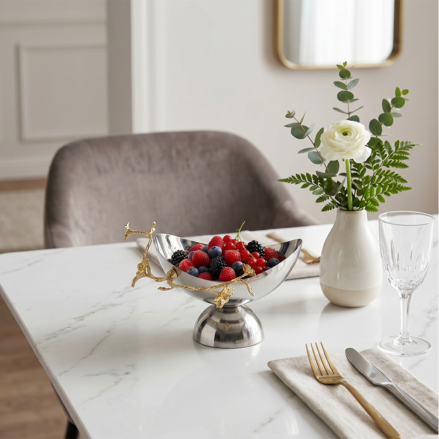 Metal fruitbowl on white dining table
