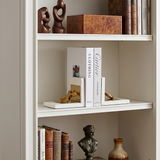 Ornament bookends on white bookshelf
