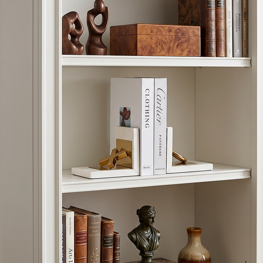 Ornament bookends on white bookshelf
