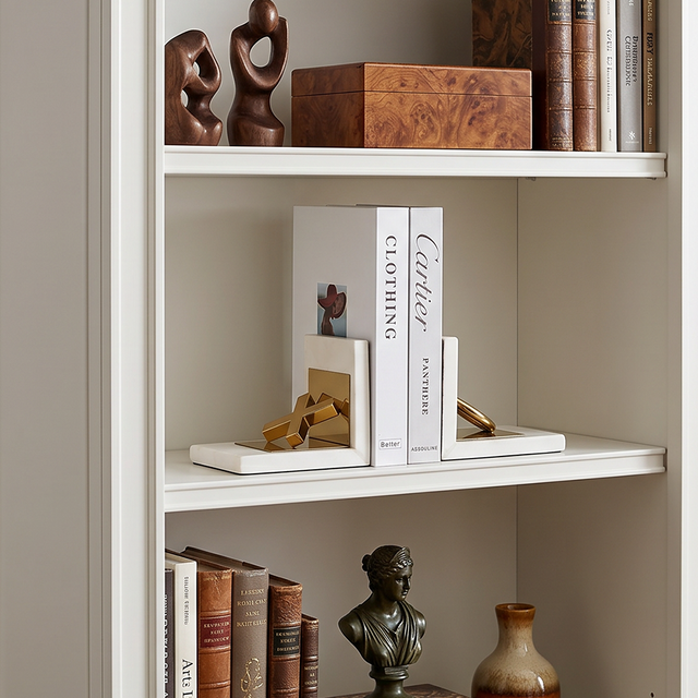Ornament bookends on white bookshelf
