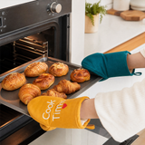 Oven mitts taking out bakery

