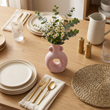 Pink ring vase on rustic dining table