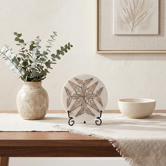 Round carved stone ornament on light dining side table