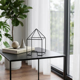 S-M wire house on black table
