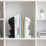 Sculpture bookends displayed in white cube shelf