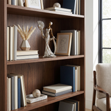 Sculpture displayed on wood bookshelf