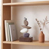 Stacked Stone Decor On Wooden Shelf