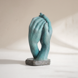 Teal clasped hands stone base sculpture
