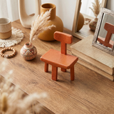 Terracotta chair ornament on rustic study-wood table