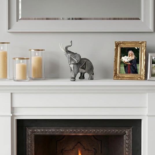 Textured elephant ornament on white fireplace mantel
