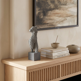 Torso statue on light wood sideboard