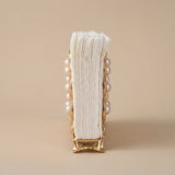 Vertical view pearl gold tissue rack