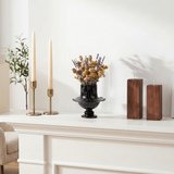 Vintage black vase on white stone fireplace shelf
