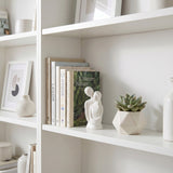 White Couple Sculpture On White Shelf