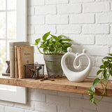 White Family Sculpture On Wooden Shelf