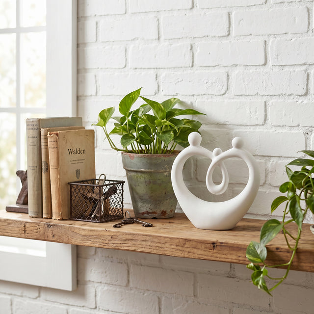 White Family Sculpture On Wooden Shelf