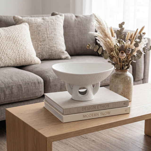 White Pedestal Bowl On Coffee Table Books