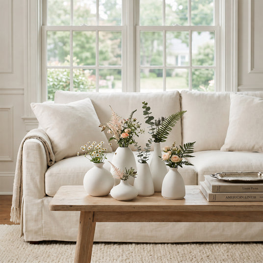 White Vases With Flowers On Coffee Table