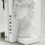 White sculpture bookend with standing books