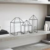 Wire house set on storage shelf
