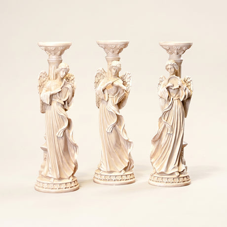 angel candle holders lineup on neutral background