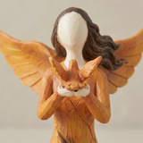 angel holding bird figurine face detail closeup