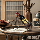 bicycle shaped wine rack on the wooden table