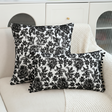black and white embroidered floral pom pom pillows