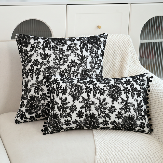 black and white embroidered floral pom pom pillows