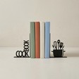 black cookbook and utensil metal bookends