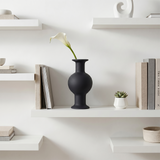 black vase on white shelf