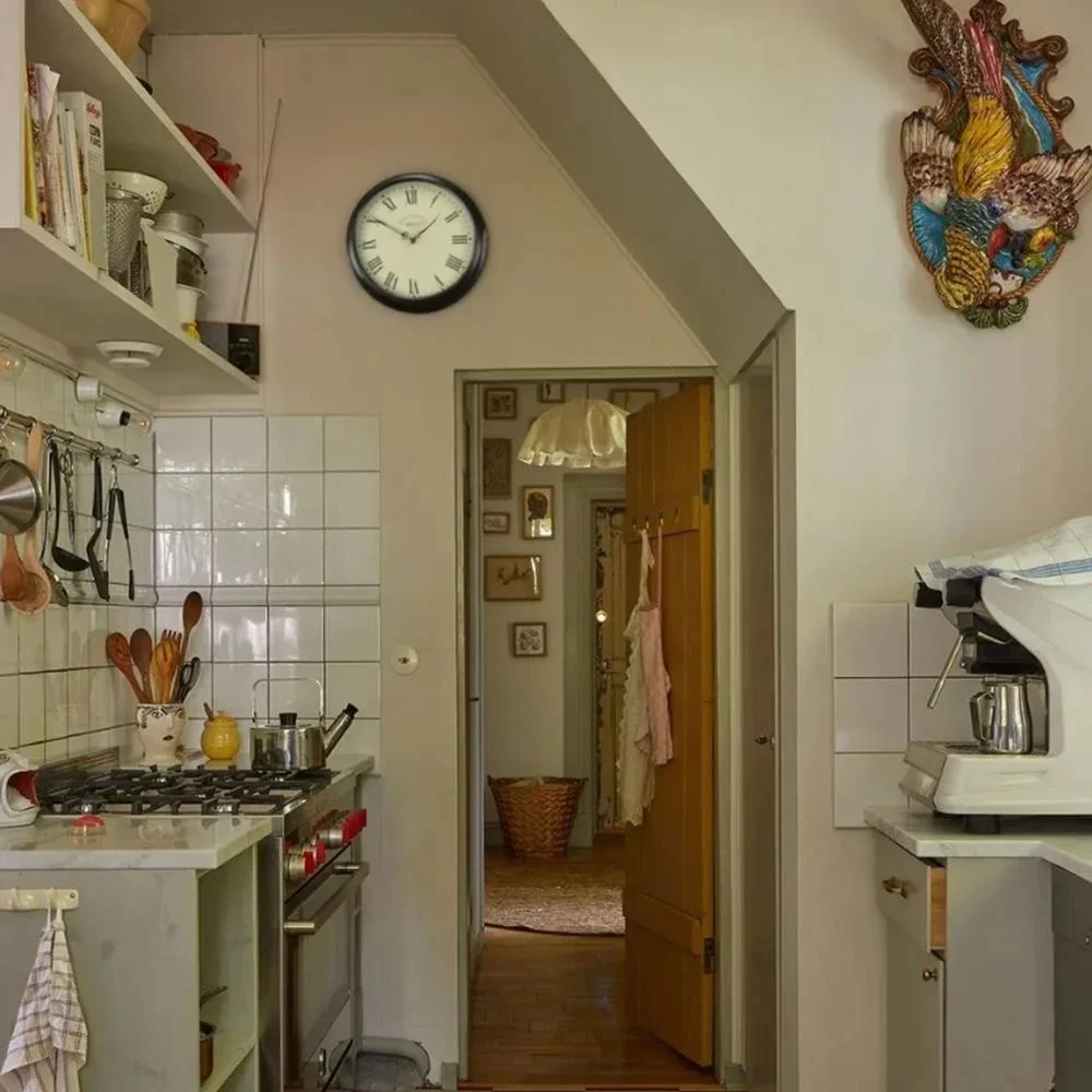 black wall clock hanging in the kitchen