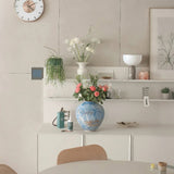 blue ceramic flower vase on the shelf