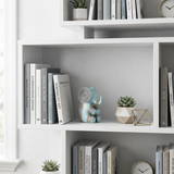 blue resin elephant on white bookshelf