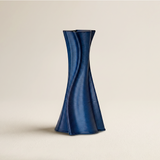 blue spiral ribbed twisted vase on beige