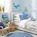 blue starfish pillow on nautical kids bed