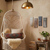 botanical signs above rattan hanging chair in corner