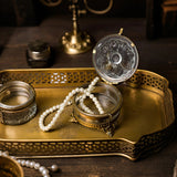 brass and glass carved decorative storage jar jewelry on the table
