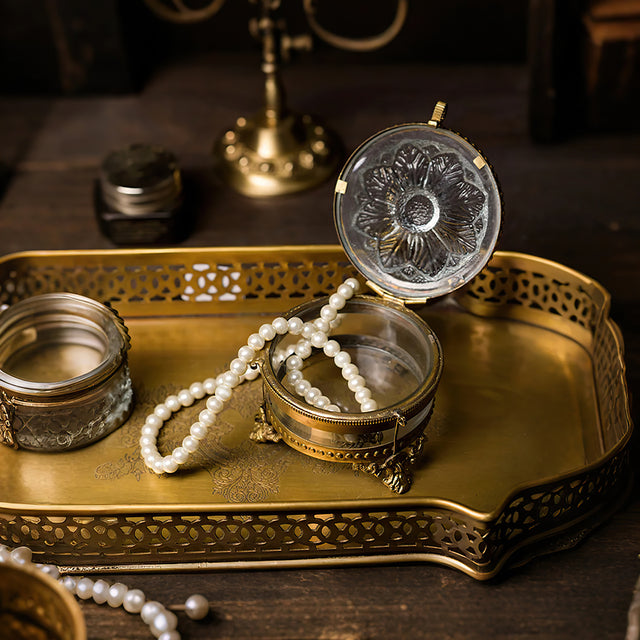 brass and glass carved decorative storage jar jewelry on the table