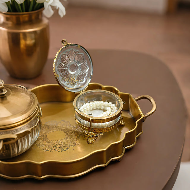 brass and glass carved decorative storage jar jewelry on the table