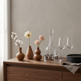 brown ceramic vases on sideboard