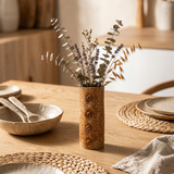 button vase with dried flowers on table